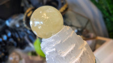 Load image into Gallery viewer, 5.5" Flat Bottom Rainbow Honey Calcite Sphere on Selenite Stand
