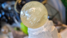 Load image into Gallery viewer, 5.5" Flat Bottom Rainbow Honey Calcite Sphere on Selenite Stand
