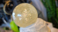 Load image into Gallery viewer, 5.5" Flat Bottom Rainbow Honey Calcite Sphere on Selenite Stand
