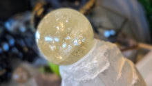 Load image into Gallery viewer, 5.5" Flat Bottom Rainbow Honey Calcite Sphere on Selenite Stand
