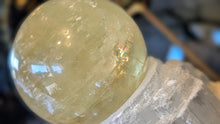 Load image into Gallery viewer, 5.5" Flat Bottom Rainbow Honey Calcite Sphere on Selenite Stand
